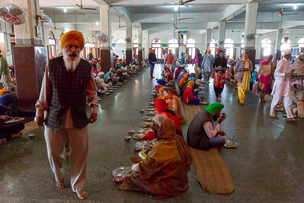 A long line of people sit and eat at the Golden Temple in Amritsar, India. 